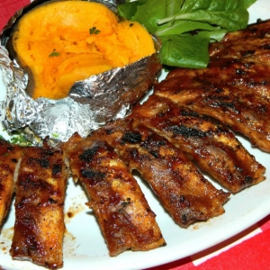 Full slab of babyback ribs with baked sweet potato