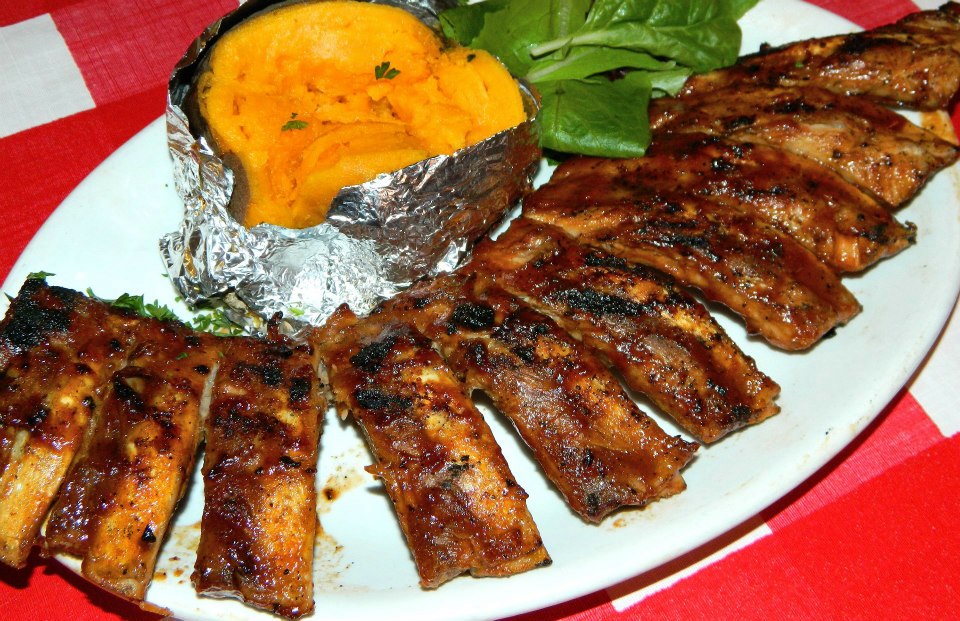 Full slab of babyback ribs with baked sweet potato