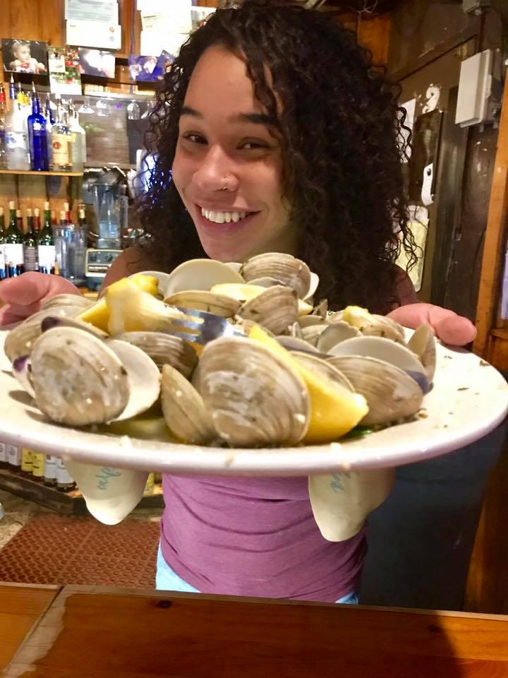 beautifil Alexandra showing an appetizer of steamed clams