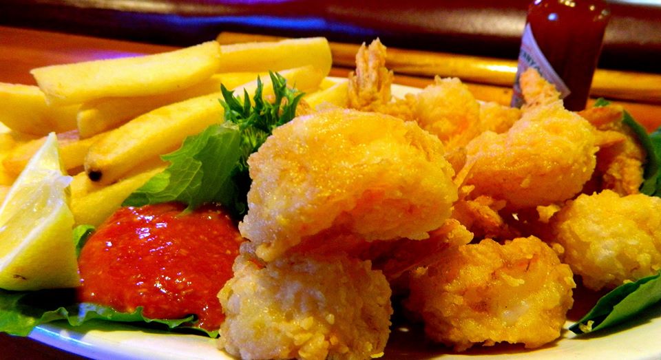 Closeup of large fried shimp and fries