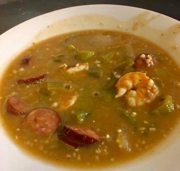 Shrimp gumbo showing how filled it is with shrimp and sausage slices